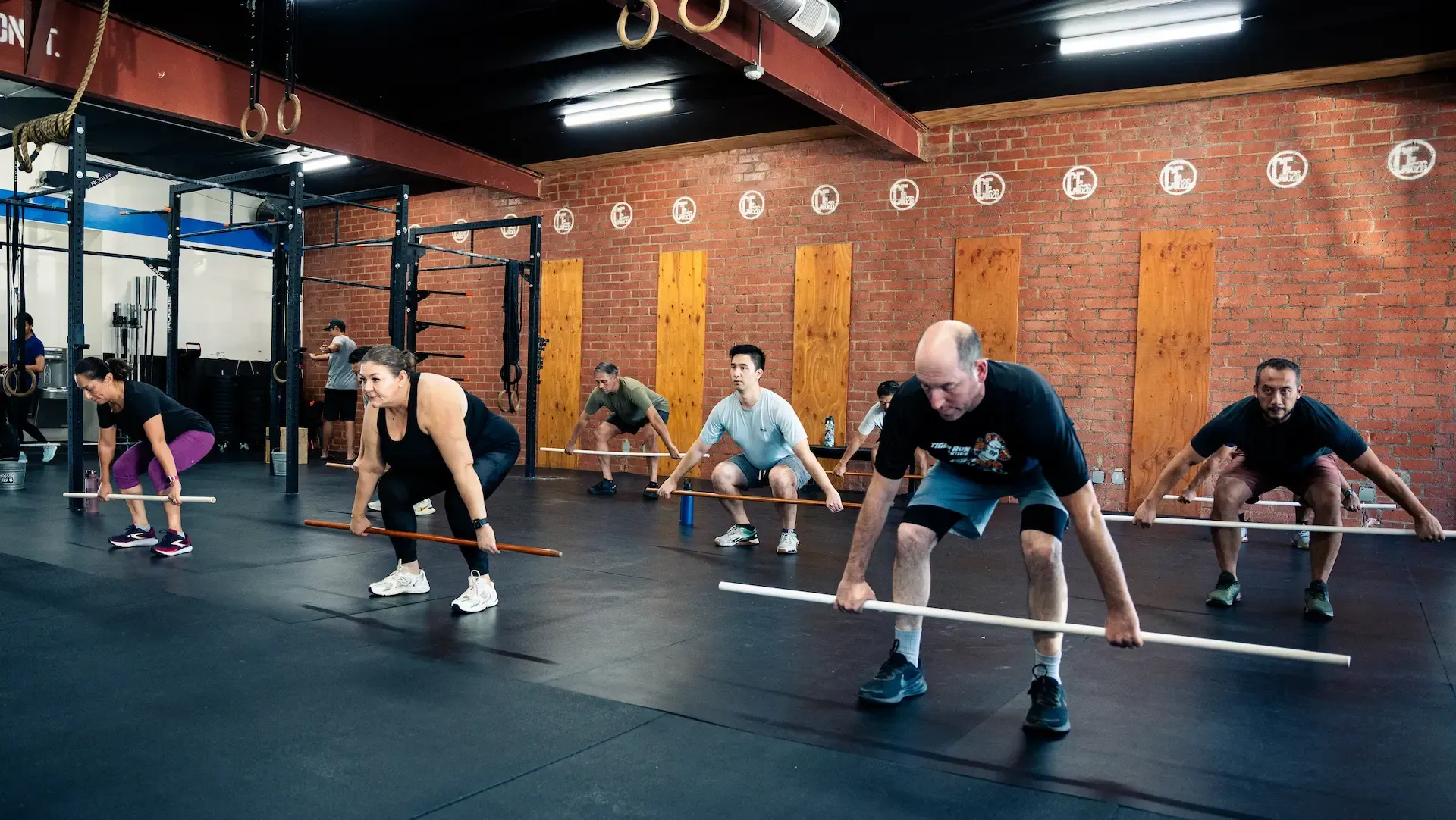 CrossFit 626 members training with barbells in a group class in San Marino